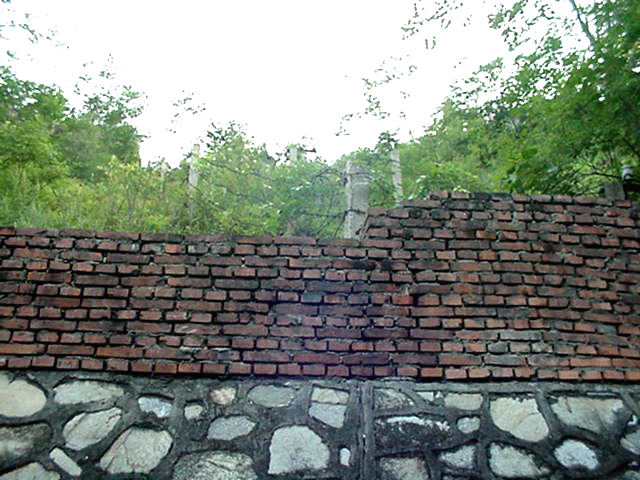 The retaining wall and barbed wire