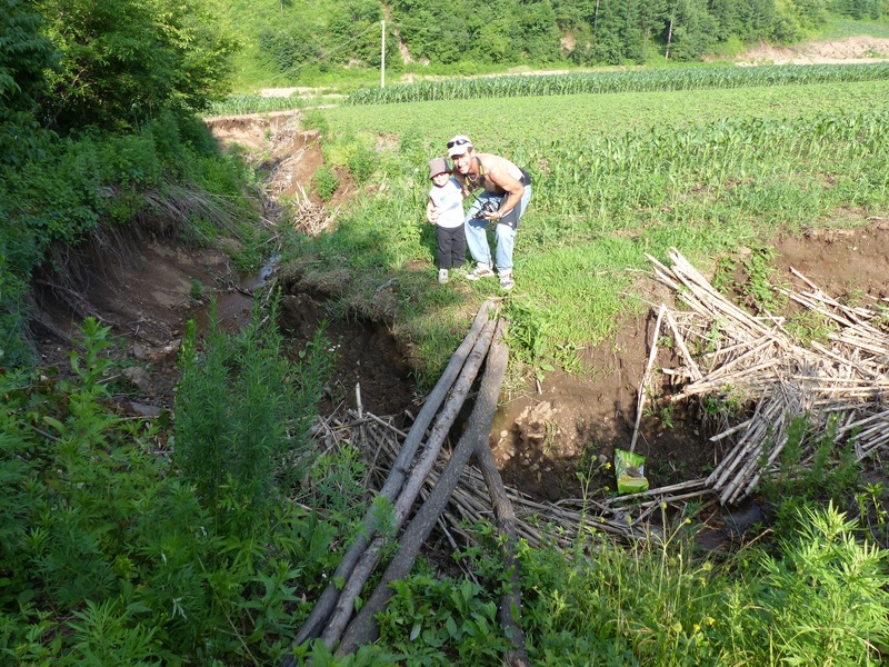 Peter and Andy preparing to cross the log bridge