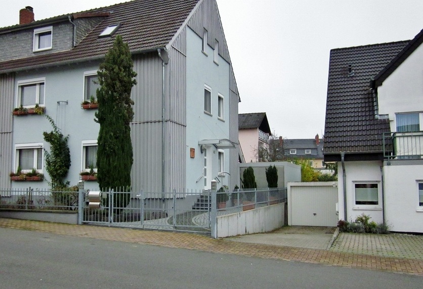 The house with the point behind the grey garage