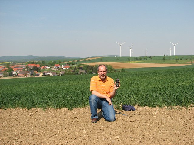Me at the spot, this view to NE shows Evensen and the widely noticeable wind turbines in the background
