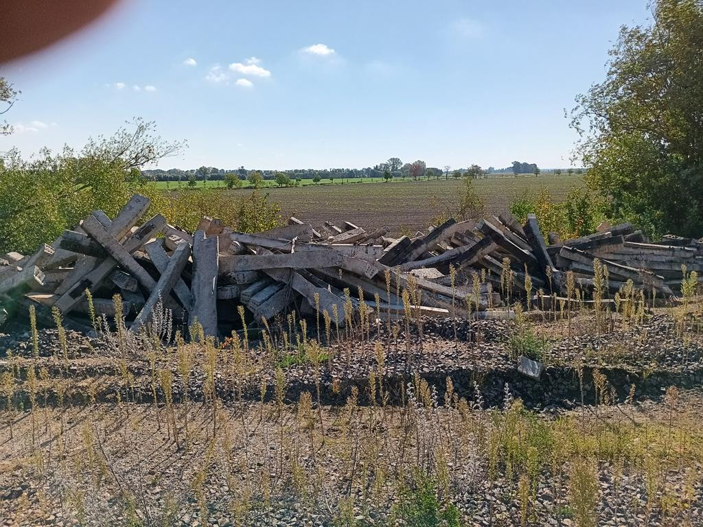 barrier of railway sleepers; towards CP field
