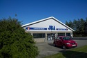 #6: The front of the JBA ("J. Block Auto") repair business.  The confluence point lies just inside the left-hand wall (hidden behind the bush)