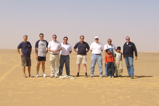 The group standing around the point with the camel bones at their feet.
