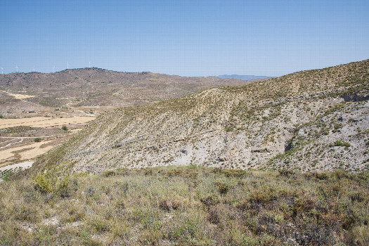 #1: The confluence point lies in scrub-covered land, at the end of a small ridge.  (Here is also a view to the North.)
