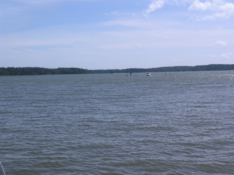 The point is located outside the sound between these two islands