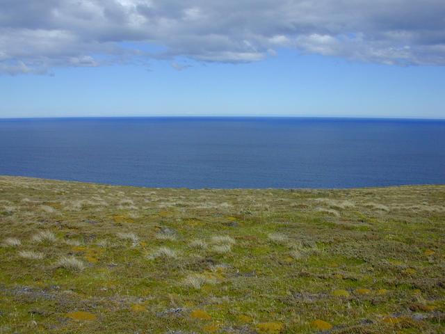 The slope to the south curves away from the eye and ends in cliffs.  Beyond lies ocean all the way to Antarctica.