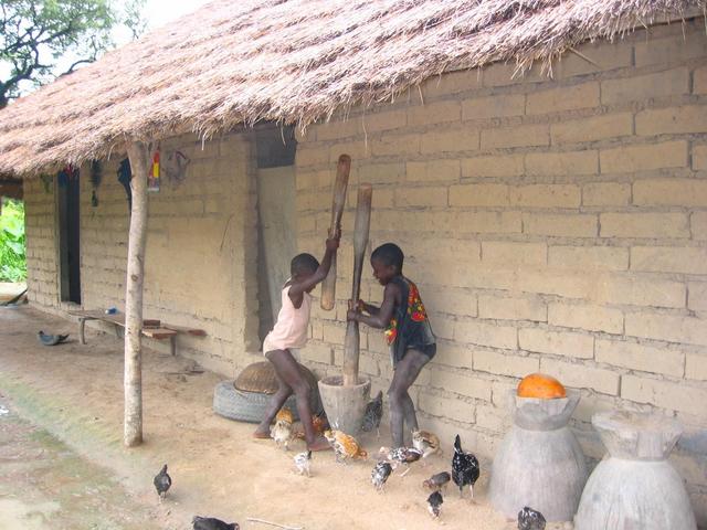 Kids grinding grain