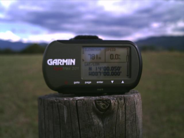 In the fence outside the field