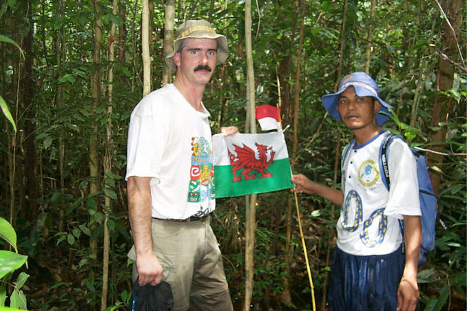 Clark and Sangkot Rifai at the confluence with the flags of Indonesia and Wales