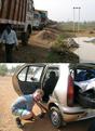 #5: Trucks lined up to pass river Subamarekha into Orissa – Michael with the puncture