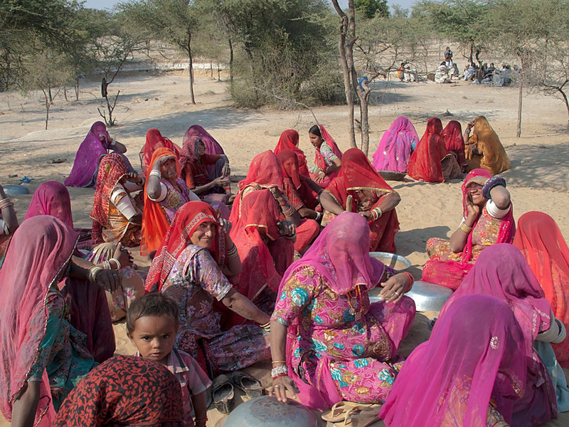 Local ladies & men (in the background) take a break from work on a Community Development Project