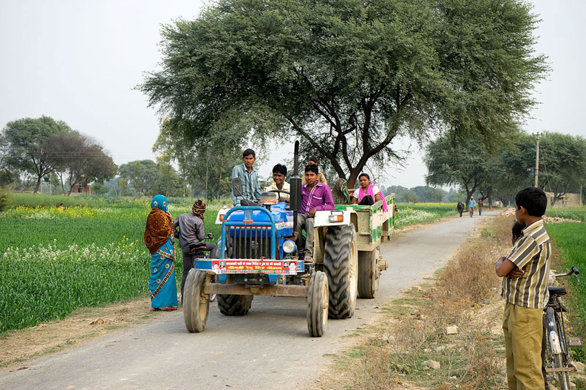 Field workers in a tractor near the confluence.