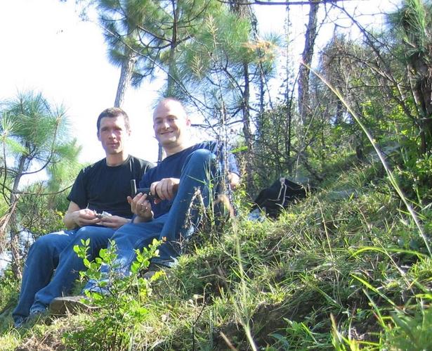 Uwe (Left) and Malcolm sitting with their feet on the confluence