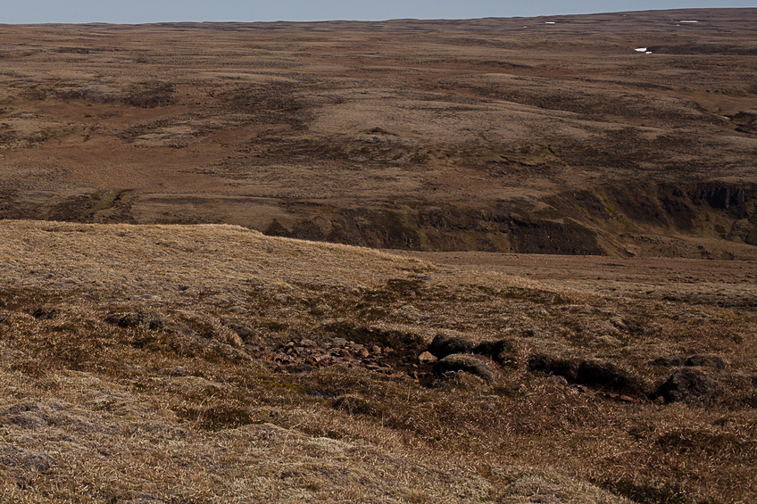 65Nx21W Overview from 1 km west of CP looking east. CP is on smooth surface 100 m beyond the little triangular hill above image center.