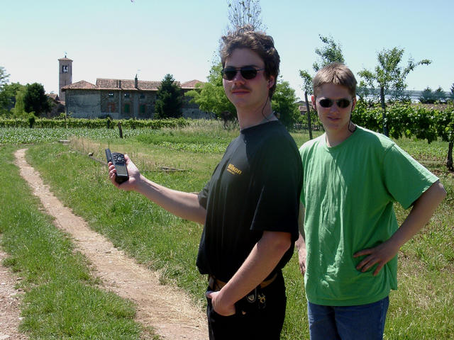 Michael and Basti approaching the confluence point on the gravel way. Background: the village San Lorenzo