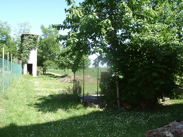 View to the East, where we came from. On the right side inside the fence is the gas tank.