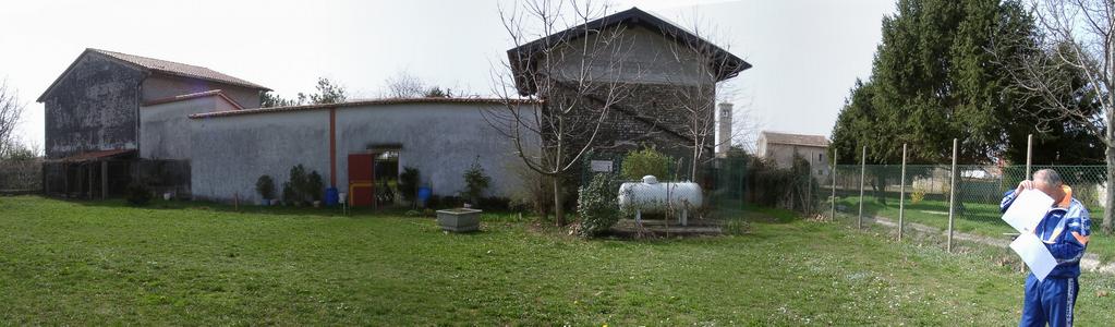 Sig. Fanutti studying the photos from visit#1 facing the back side of his house