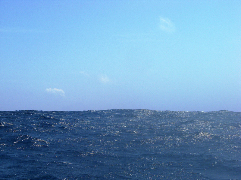 Looking south from the confluence in the direction of the nearest land.  The Yokoate-jima volcano is located (promise!)  just under the small cloud on the left.