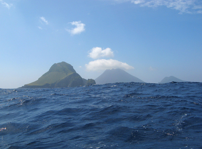 Kaminone-jima (foreground) and Yokoate-jima in a rolling sea; on the way to the confluence. My brother commented our our blog, "you guys are floating around in a life size Zen garden".  And so it was.