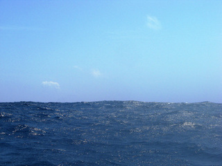 #1: Looking south from the confluence in the direction of the nearest land.  The Yokoate-jima volcano is located (promise!)  just under the small cloud on the left.