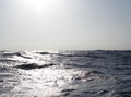 #5: looking east - no land visible; the small object on the right is some kind of large floating platform being towed southward