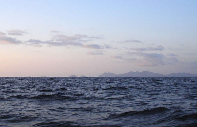 Looking just west of south.  Rocks and islets and the steep hills of the Koshiki group are visible.