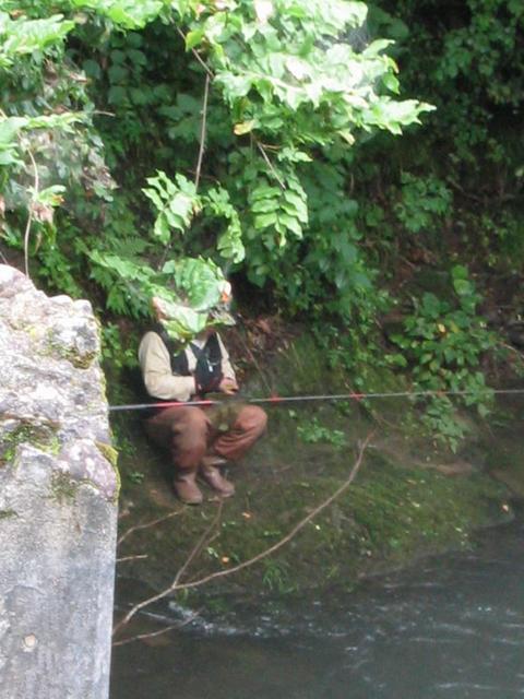 Fisherman next to bridge.