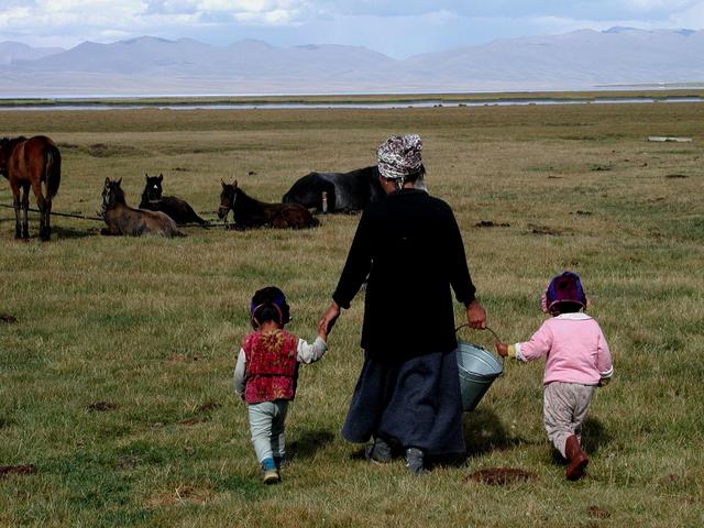 Family living by the lake shore - going to collect horse