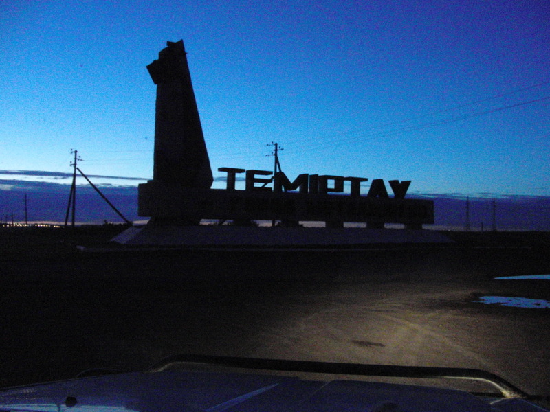 Letters at the entrance of Temirtau in the dark