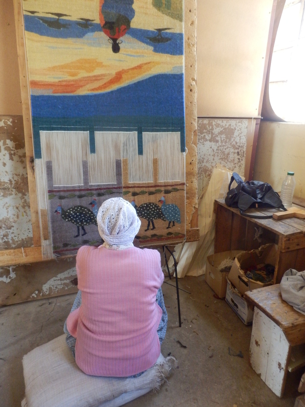 Woman weavering a carpet in Teyateyangeng