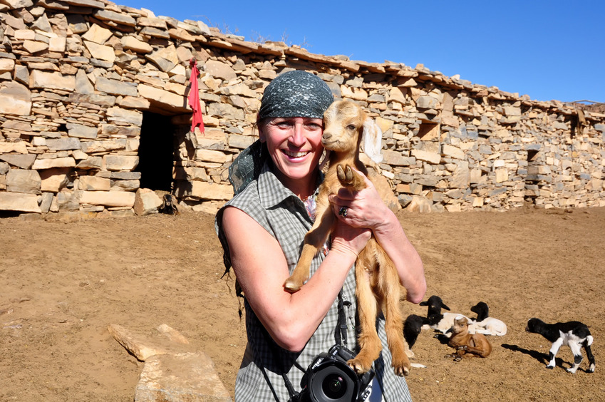 Dominique with goats inside the azib