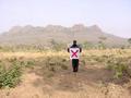 #3: Ibrahim with the flag on the Confluence, looking west