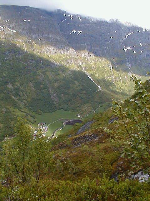 View from the north end of the valley of the confluence, down to the valley below, the farm Vollset, the start of Flovegen over to Strynevannet