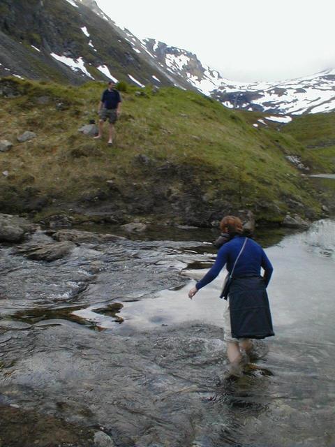 Gjertrud vading the small river in the valley of the confluence. Cold.