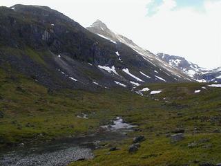 #1: View south to the confluence. The confluence is on the slope in the left of the picture, about where the strip of sun is.