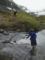 #6: Gjertrud vading the small river in the valley of the confluence. Cold.