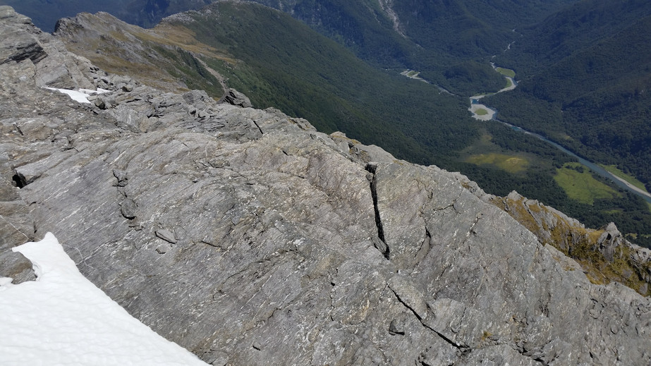 Looking down onto the confluence from the cliff above and beyond to the valley below