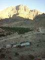 #5: Jabal Thanab with the winding road to the wādiy al-`Arabiyyīn. Also: Date palm groves.