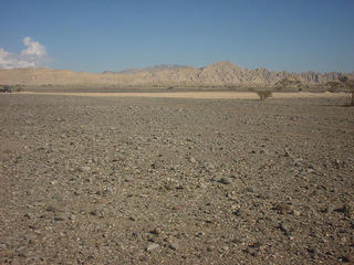 #1: The Confluence in the foreground looking east. The Hajar Mountains in the distance.