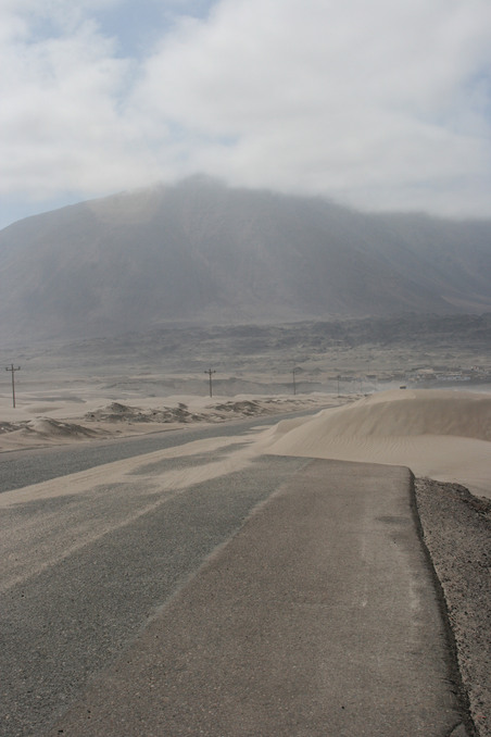 Sand dunes over road