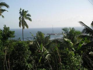 #1: A view of Recodo located along the Caldera Bay as seen from the closest point I got to the Confluence. Note: Outline of Basilan Island over the horizon on the left side of the photo.