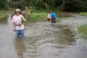 #2: Santah never missed the chance to pick flowers while wading through the flooded road. Flood is a washing opportunity for two residents.