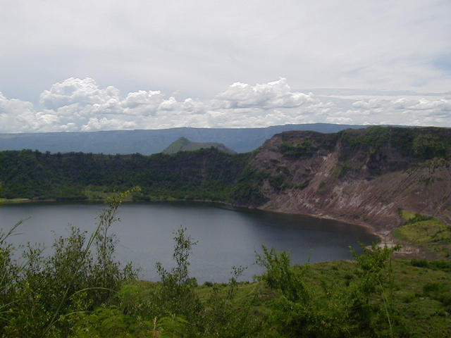 View looking NE from rim of Binitiang Malaki volcano lake, the largest on the island. Last erupted in 1715. Steam could be seen escaping from vents on the right side of the shore (scorched area).