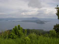 #3: The confluence sits on the backside of Volcano Island (center of photo) in Taal Lake. View is SSE from the town of Tagatay on the northern rim of the pre-historic Taal Volcano. The Southern rim and Mt. Maculot (shrouded in clouds) are in the background.