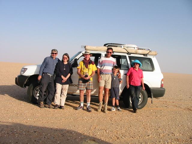 Putting on brave faces after an utterly boring drive to the confluence.