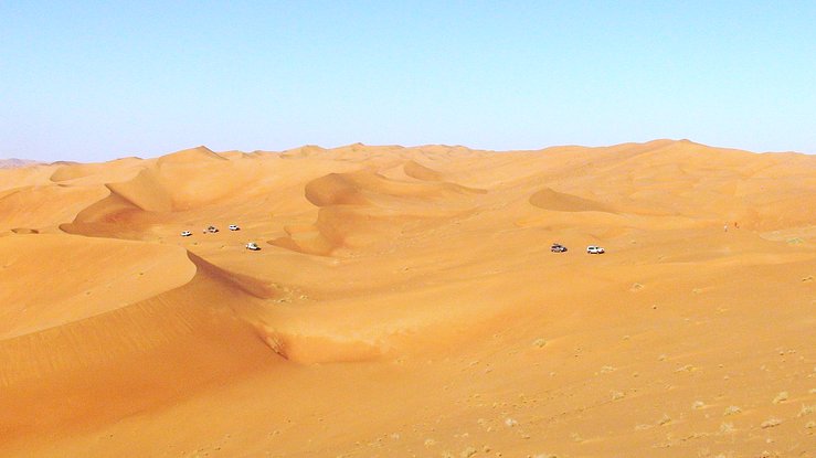 Six vehicles navigating through the dunes