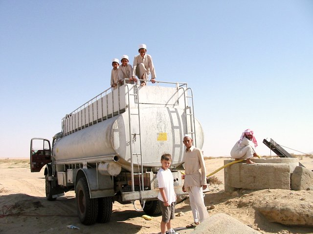 A water tanker supping from the well.