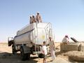 #6: A water tanker supping from the well.