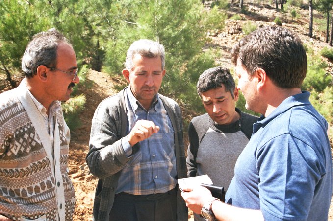 Berkant (R) is getting instructions from village mayor (C)