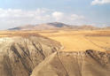 #3: View north across a deep erosion trench towards the Confluence, still 2.4 km away